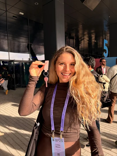 Linny holding up her pink Babes Net key outside the conference centre